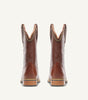 Custom brown cowboy boot with embossed black floral leather upper - side view
